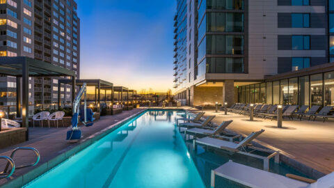 Country Club Towers pool area with comfortable lounge chairs and gazebos under Colorado sunset skies.